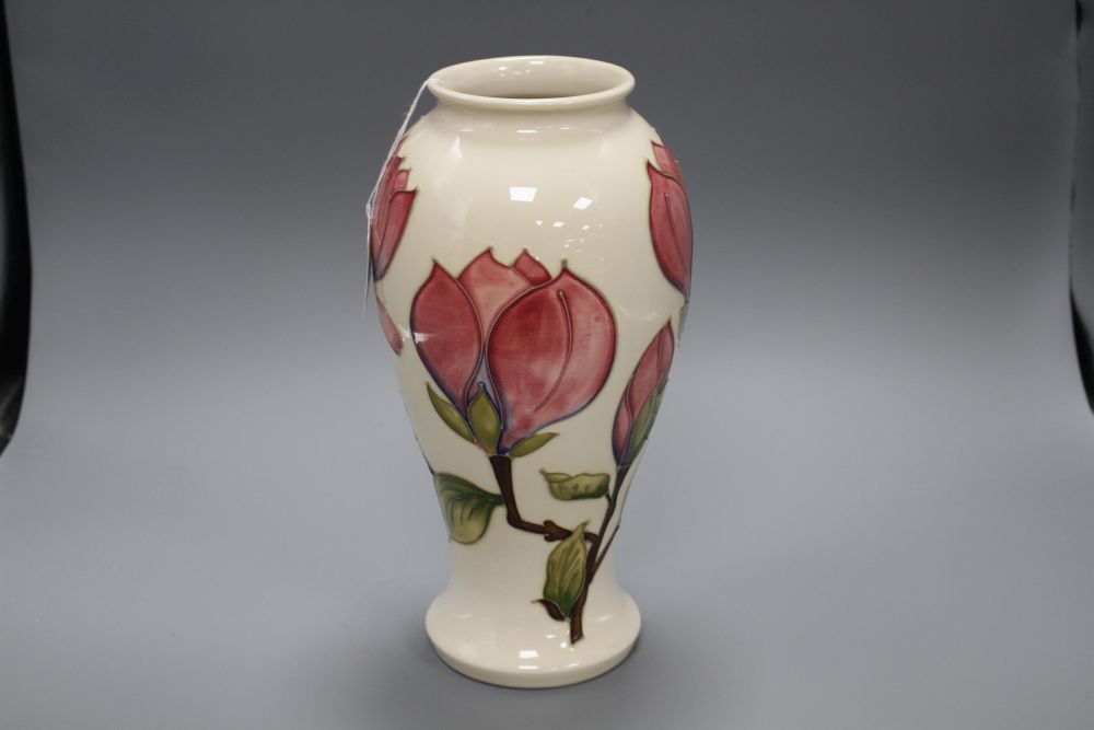 A Moorcroft magnolia pattern baluster vase, with pink flowers on a cream ground, height 31cm